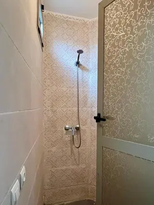 a shower with a glass door in a bathroom at Apartment with rooftop access in Marrakech