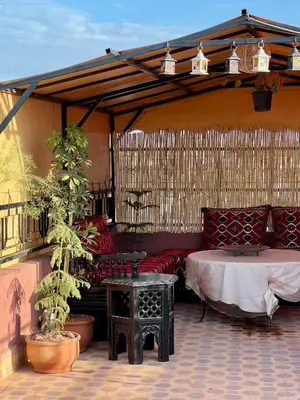 a patio with a table and chairs and a tent at Apartment with rooftop access in Marrakech
