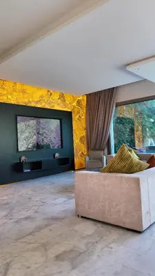 a living room with a couch and a flat screen tv at VILLA Zamzam in Marrakech