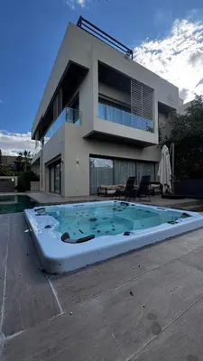 a large swimming pool in front of a house at VILLA Zamzam in Marrakech