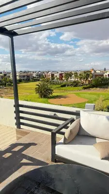 a white couch sitting on top of a patio at VILLA Zamzam in Marrakech