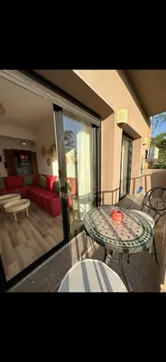 a living room with a table and a couch at Rouge Mamounia in Marrakech