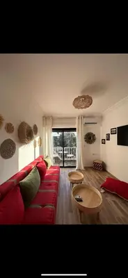 a living room with a red couch and a table at Rouge Mamounia in Marrakech