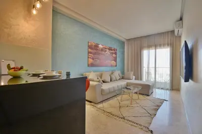 a living room with a couch and a table at Central location-Queensize bed- Parking, AC & Iptv in Marrakech
