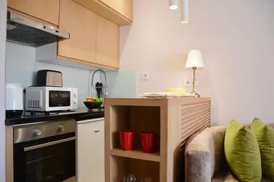 a kitchen with a counter with a microwave and a stove at 1BR Studio-AC & IpTV-Downtown Gueliz-perfect for 2 in Marrakech