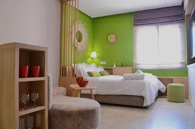 a bedroom with a bed and a green wall at 1BR Studio-AC & IpTV-Downtown Gueliz-perfect for 2 in Marrakech