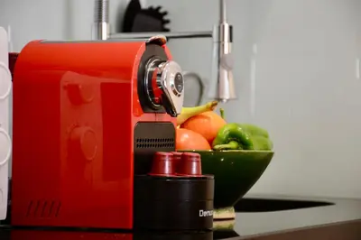 a red mixer on a counter with a bowl of fruit at 1BR Studio-AC & IpTV-Downtown Gueliz-perfect for 2 in Marrakech