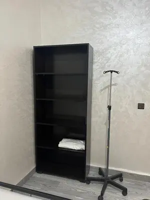 a black shelf in a room with a treadmill at Apartment near the airport in Marrakech