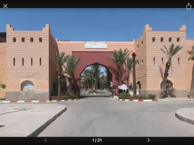 a large building with an arch in the middle of a street at Riyad jennah in Marrakech