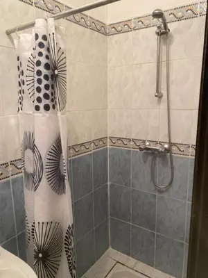 a shower with a shower curtain in a bathroom at Riyad jennah in Marrakech