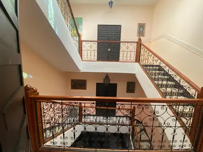 a staircase in a home with a black door at Riyad jennah in Marrakech