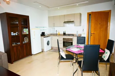 a kitchen and dining room with a table and chairs at Luxury Odyssey Private Pool in Marrakech