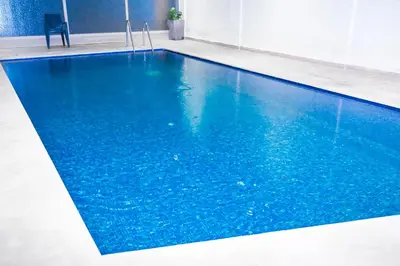 a swimming pool with blue water in a room at Luxury Odyssey Private Pool in Marrakech