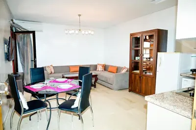 a kitchen and living room with a table and chairs at Luxury Odyssey Private Pool in Marrakech