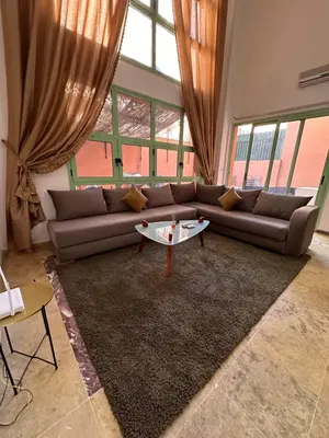 a living room with a couch and a table at Duplexe Mirador Majorelle in Marrakech