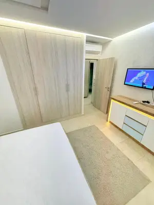 a living room with a flat screen tv on a wall at Luxueux Aprt A Gat Moderne Centre-ville in Marrakech