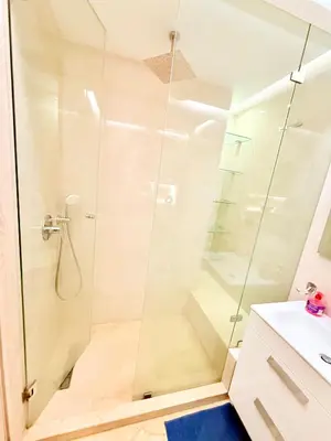 a shower with a glass door in a bathroom at Luxueux Aprt A Gat Moderne Centre-ville in Marrakech