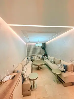 a living room with a couch and two tables at Luxueux Aprt A Gat Moderne Centre-ville in Marrakech