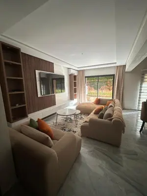 a living room with two couches and a table at Appartement avec piscine Marrakech in Marrakech
