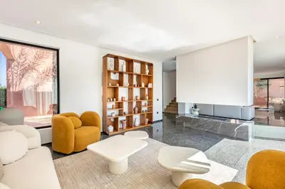 a living room with white furniture and a large window at La Villa Karl in Marrakech