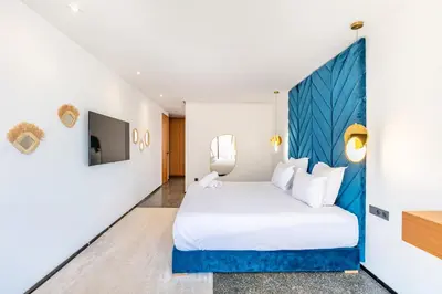 a hotel room with a bed and a tv at La Villa Karl in Marrakech