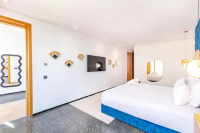 a bedroom with a bed and a wall with mirrors at La Villa Karl in Marrakech