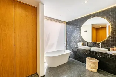 a bathroom with a large tub and a mirror at La Villa Karl in Marrakech
