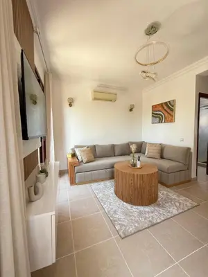 a living room with a couch and a table at Appartement La Palmeraie Marrakech in Marrakech