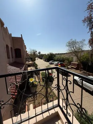 a balcony with potted plants on a building at Appartement La Palmeraie Marrakech in Marrakech