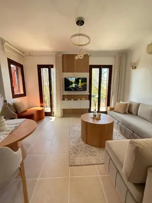 a living room with a couch and a table at Appartement La Palmeraie Marrakech in Marrakech