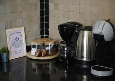 a counter top with a coffee maker and a coffee pot at Peaceful 2BR Oasis with Pool Tennis AC - Palmeraie in Marrakech