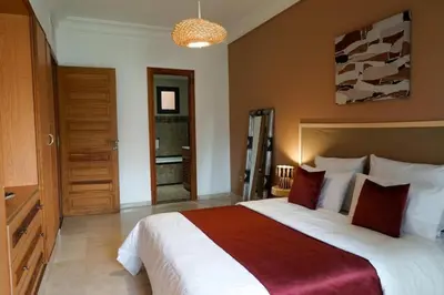 a bedroom with a large bed in a room at Peaceful 2BR Oasis with Pool Tennis AC - Palmeraie in Marrakech