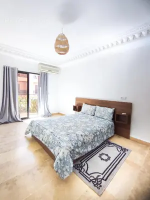 a bedroom with a bed and a large window at Eden Orientale in Marrakech