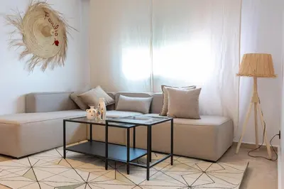 a living room with a couch and a table at Modern & Chic Apartment in Gueliz, Marrakech in Marrakech