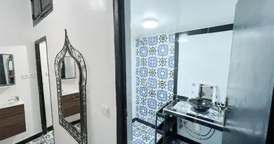 a bathroom with a sink and a mirror at Dar ESSEKIA in Marrakech