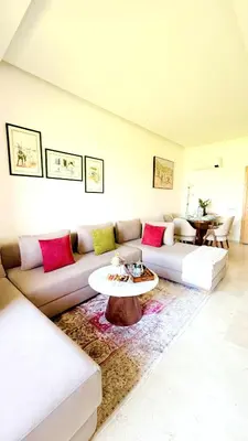 a living room with a couch and a table at Marrakech confort et détente à Argan Golf prestigia in Marrakech