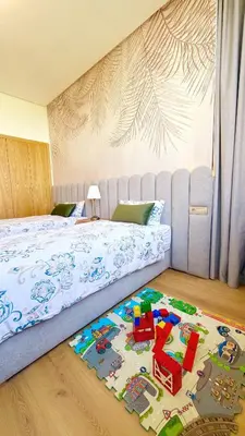 a bedroom with a bed with a toy rug on the floor at Marrakech confort et détente à Argan Golf prestigia in Marrakech