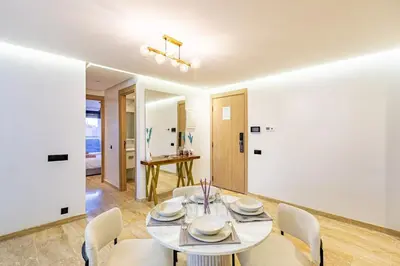 a dining room with a white table and chairs at 1BR appt in the centre gueliz in Marrakech