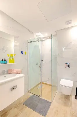 a bathroom with a glass shower and a toilet at 1BR appt in the centre gueliz in Marrakech