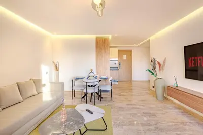a living room with a couch and a table at 1BR appt in the centre gueliz in Marrakech