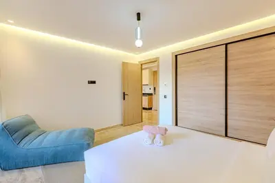 a bedroom with a white bed and a blue couch at 1BR appt in the centre gueliz in Marrakech