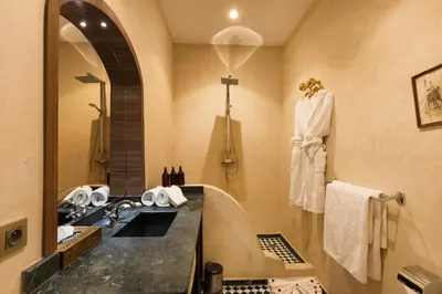 a bathroom with a sink and a mirror at PL Place Boutique Hôtel & Restaurant in Marrakech