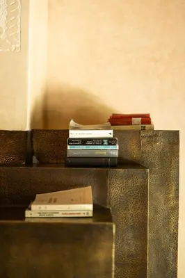 a stack of books sitting on top of a table at PL Place Boutique Hôtel & Restaurant in Marrakech