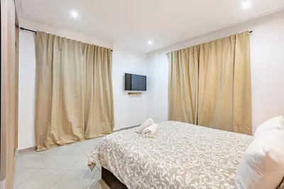 a bedroom with a bed and a flat screen tv at Super apartment in marrrakech in Marrakech