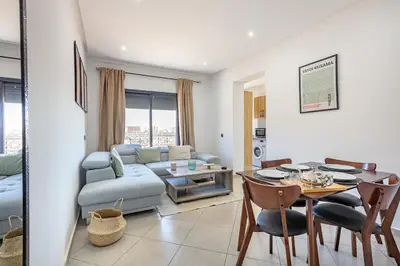 a living room with a table and a couch at Super apartment in marrrakech in Marrakech