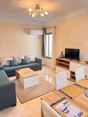 a living room with a couch and a tv at Appartement Marrakech in Marrakech