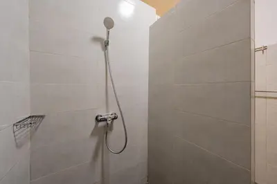 a shower with a shower head in a bathroom at Dar KADO, Charming Hideaway in the Heart of Marrakech Medina in Marrakech
