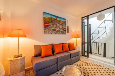 a living room with a couch and a window at Dar KADO, Charming Hideaway in the Heart of Marrakech Medina in Marrakech