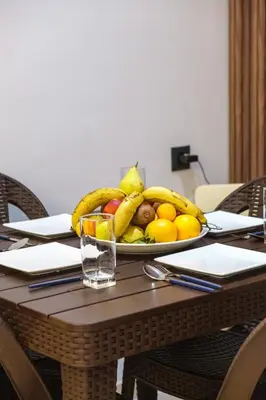 a plate of fruit on a wooden table at 3 min de Guéliz - Appart avec balcon , vue piscine in Marrakech