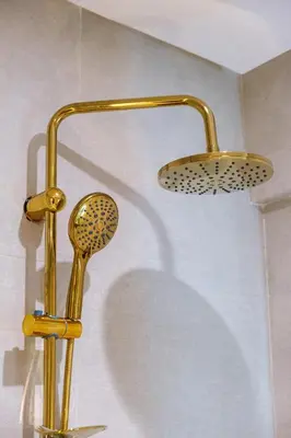a shower with two lights on the wall at 3 min de Guéliz - Appart avec balcon , vue piscine in Marrakech